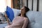 Overheated woman sit on sofa wave hand fan reduce heat