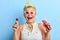 Overjoed positive funny woman holding a lollipop and a bottle of juice