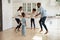 Overjoyed african american couple jumping with joyful energetic children.