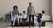 Overjoyed african american family having fun together in living room.