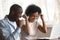 Overjoyed african couple celebrate online victory sit at table