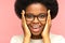 Overjoyed african female emotional with mouth open. Excited young black woman in eyeglasses amazed