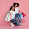 Overjoyed Afro Woman And Little Daughter Posing With Lots Shopping Bags