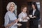 Overjoyed colleagues drinking coffee together in an office