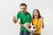 Overjoyed couple, woman man, football fans in yellow green t-shirt cheer up support team with soccer ball doing winner