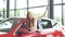 Overjoyed driver woman smiling and showing new key while sitting in car showroom