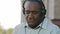 Overjoyed emotional senior African American man wearing headphones have fun moving listening music relax happy mature