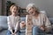 Overjoyed grandmother and granddaughter play stacking game