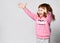 Overjoyed happy smiling little toddler girl in sportswear studio shot