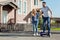 Overjoyed man riding hoverboard with his wifes help