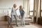 Overjoyed mature mother and adult daughter dance at home