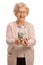 Overjoyed mature woman holding a jar filled with money