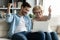 Overjoyed mature woman and young man looking at laptop screen