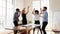 Overjoyed millennial diverse mixed race business people dancing in office.