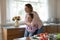 Overjoyed mother and teen daughter have fun cooking together