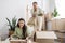 overjoyed multiracial woman holding glass vase