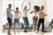 Overjoyed multiracial young people dancing together indoors