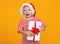 Overjoyed preschool lovely boy in red Santa hat holding such long-awaited Christmas gift