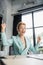 overjoyed redhead businesswoman in eyeglasses showing