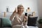 Overjoyed satisfied middle aged woman showing thumb up, holding smartphone