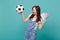 Overjoyed screaming young woman football fan support favorite team with soccer ball, fan of money in dollar banknotes