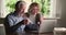 Overjoyed smiling elderly couple getting email with unbelievable news.