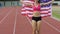 Overjoyed sportswoman enjoying sports victory and holding flag of USA, slow-mo
