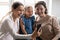 Overjoyed three generations female family posing for mobile selfie.