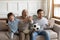 Overjoyed three generations of men watching match, supporting favorite team