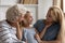 Overjoyed three generations of women relax at home