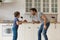 Overjoyed young father sing in home kitchen with son