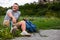 Overjoyed young man with disability resting on the grass