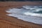 OVERLAPPING WAVES PUSHING OVER THE BEACH