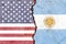 Overlay of the American and Argentine flags on a weathered cracked wall background