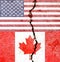 Overlay of the American and Canadian flags on a weathered cracked wall background.