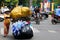 Overloaded motorbike with collected plastic bottles in traffic of Saigon