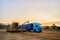 Overloading grain from the combine harvesters into a grain truck in the field. Harvester unloder pouring just harvested