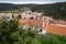 Overlook from a hill, looking over the rooftops of houses and buildings of Odeceixe, Portugal, a town in the Algarve