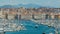 Overlook of Marseille harbor with many sail boats moored densely, cityscape
