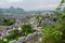 Overlook from stone wall to ancient town in mountains on cloudy