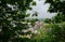 Overlook to ancient town from woody hillside in cloudy spring