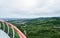 Overlooking rual landscape from glass paved footbridge in cloudy summer