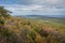 Overlooking the Shawangunk Mountain Range surrounded by bright fall foliage on a partly cloudy afternoon at Minnewaska State Park,