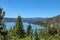 Overlooking Wiskey Lake in Northern California surrounded by pine trees with a twisting road headed west through the mountians