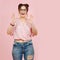 Overly positive eccentric lady throwing hands up in joy. Over pink background