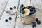 Overnight oats with blueberries and bananas on a white wood background