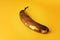 Overripe Banana on yellow background. Very ripe brown spotted organic banana. Shallow depth of field image