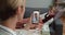 Overshoulder view of woman holding smartphone and communicating with female mature doctor. Mother having online medical
