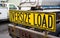 Oversize load sign on the back of big rig semi truck tractor on