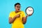 Oversized African Woman Showing Clock Posing Standing Over Blue Background